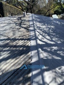 corrugated roof fully covered with waterproofing, with the other side still in progress.