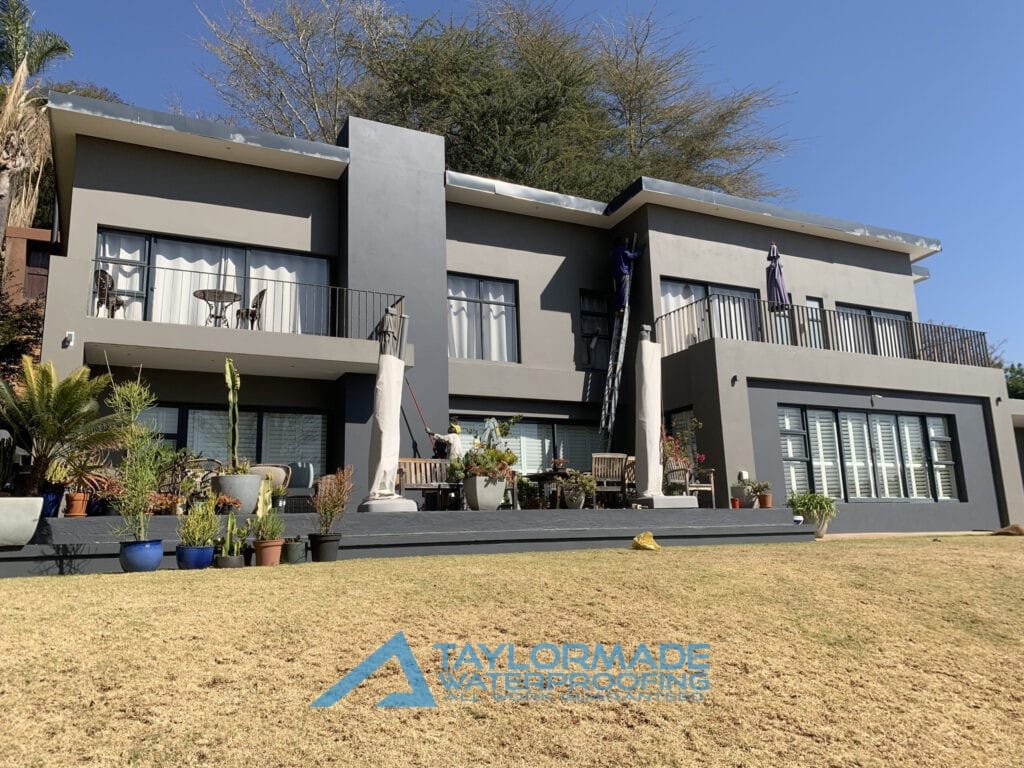 house wall after crack repair and waterproof paint application, showing a smooth and renewed surface.