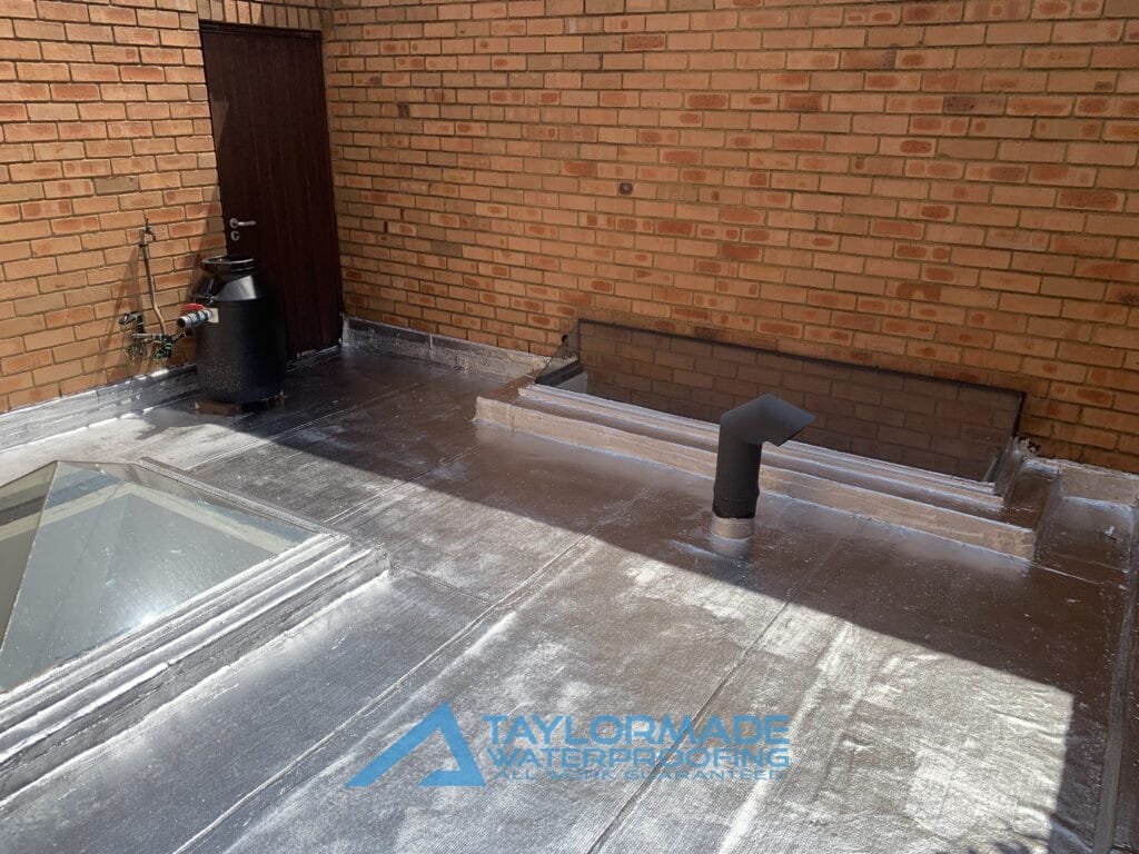 Flat Roof with torch-on membranes and painted in sliver applied, showing waterproofing protection.