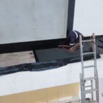 TM Waterproofing applying torch-on bitumen membrane on a balcony surface for durable waterproofing protection.