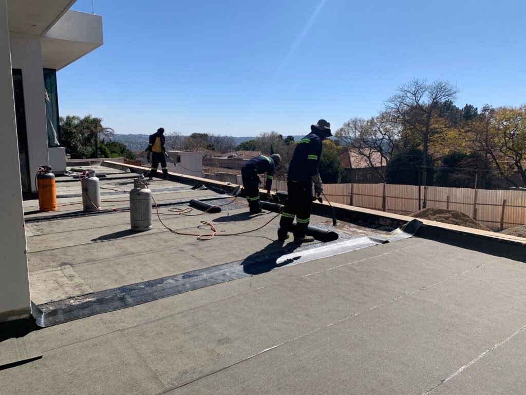 TM Waterproofing applying waterproofing membrane on the balcony of a luxury Sandton home.