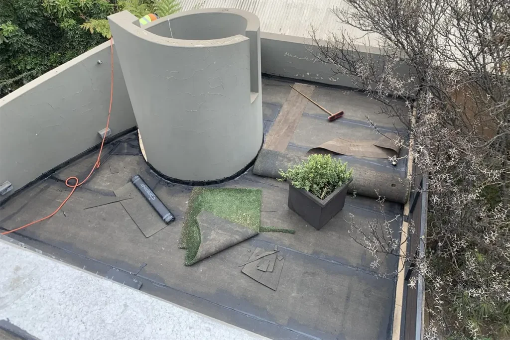 top view of balcony waterproofing Parktown North worker applying protective roof coating