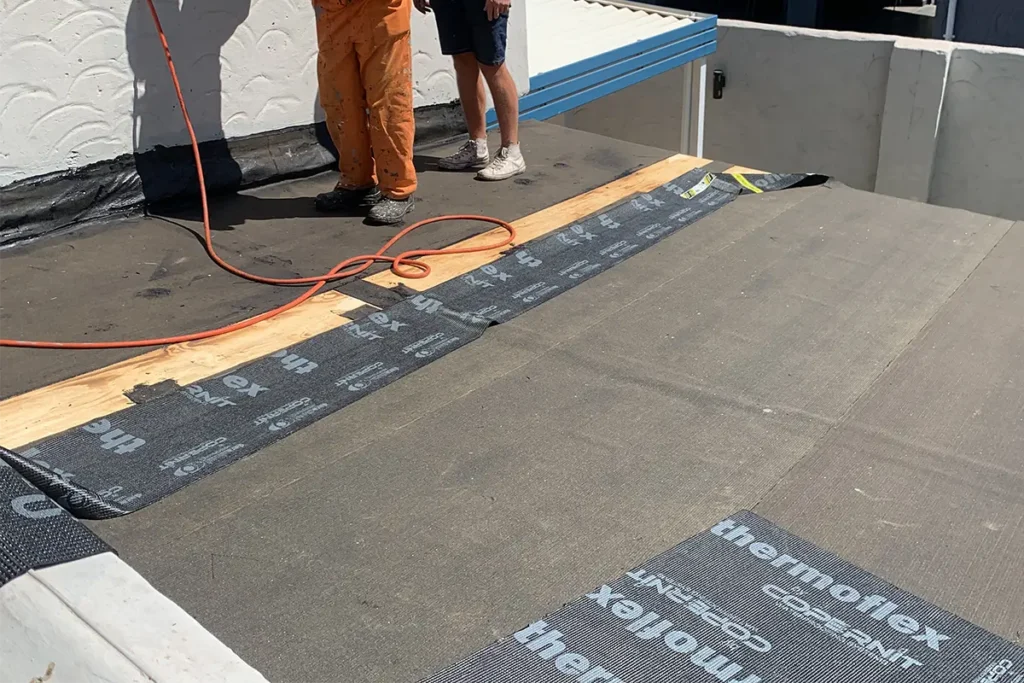 torch-on waterproofing Roodepoort membrane being applied to flat roof