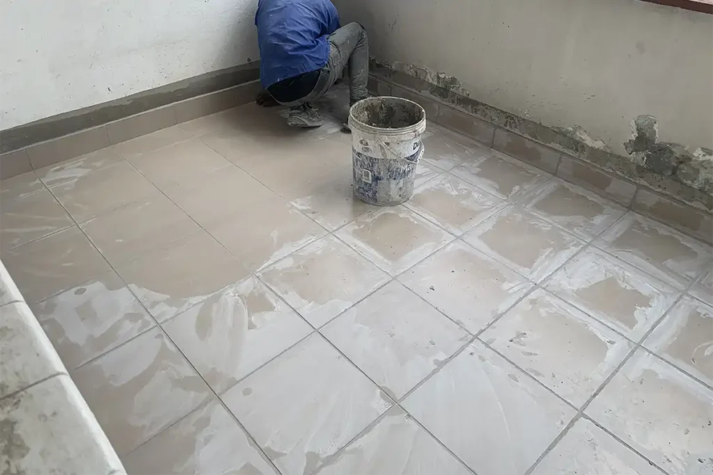 Balcony retiling waterproofing Craighall final tiled floor with worker after waterproofing