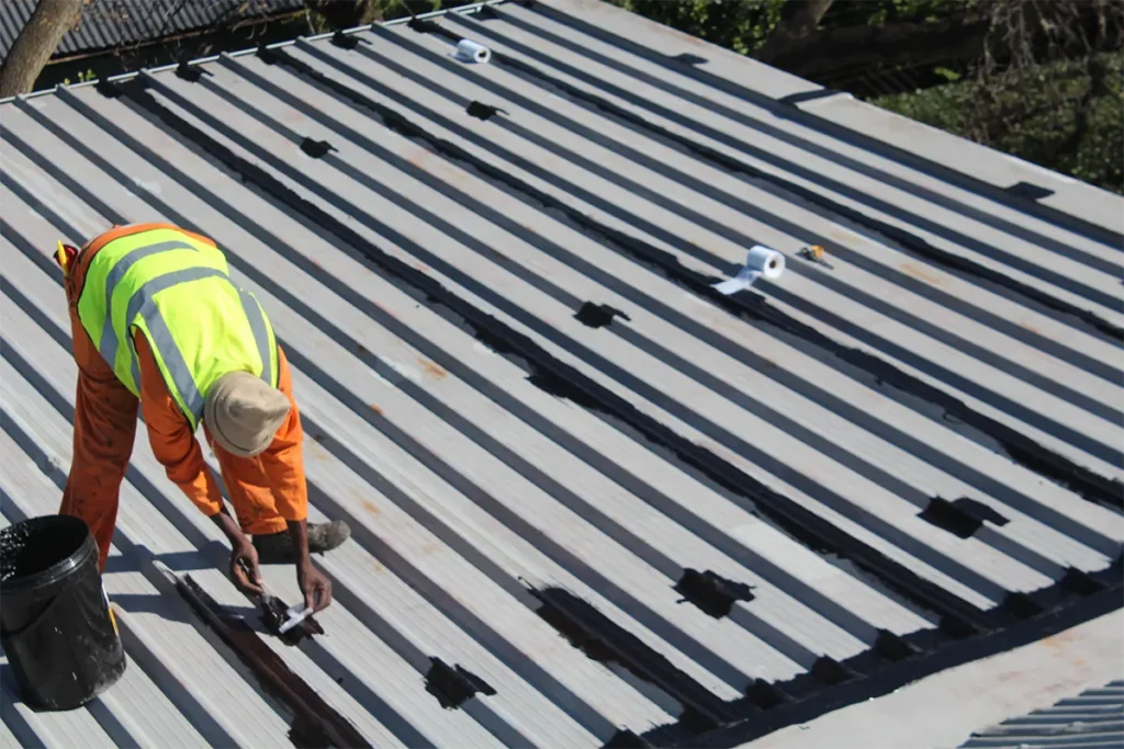 Daraflex waterproofing being applied to prefab corrugated plastic roof in Westcliff