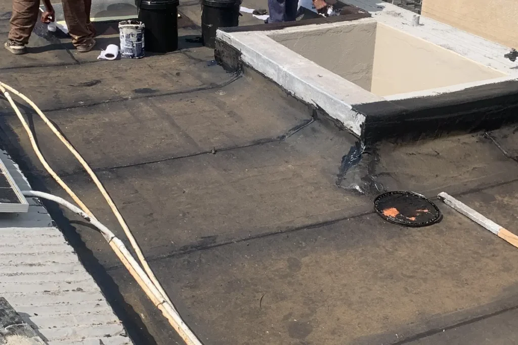 Flat roof waterproofing Parkhurst with new torch-on membrane installed and edge sealing in progress