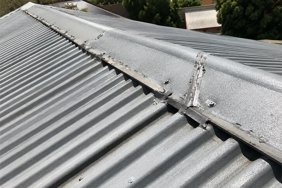 Metal roof waterproofing Johannesburg image showing sheet overlaps, ridge cap gaps and corrugated roof joints