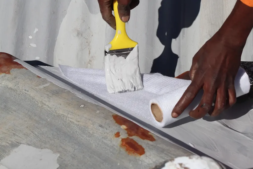 Roof waterproofing Westcliff close up of white coating applied over reinforced fabric detail