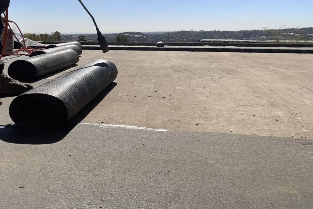 Roof & Exterior Wall Waterproofing Westcliff torch-on membrane being applied to a flat roof
