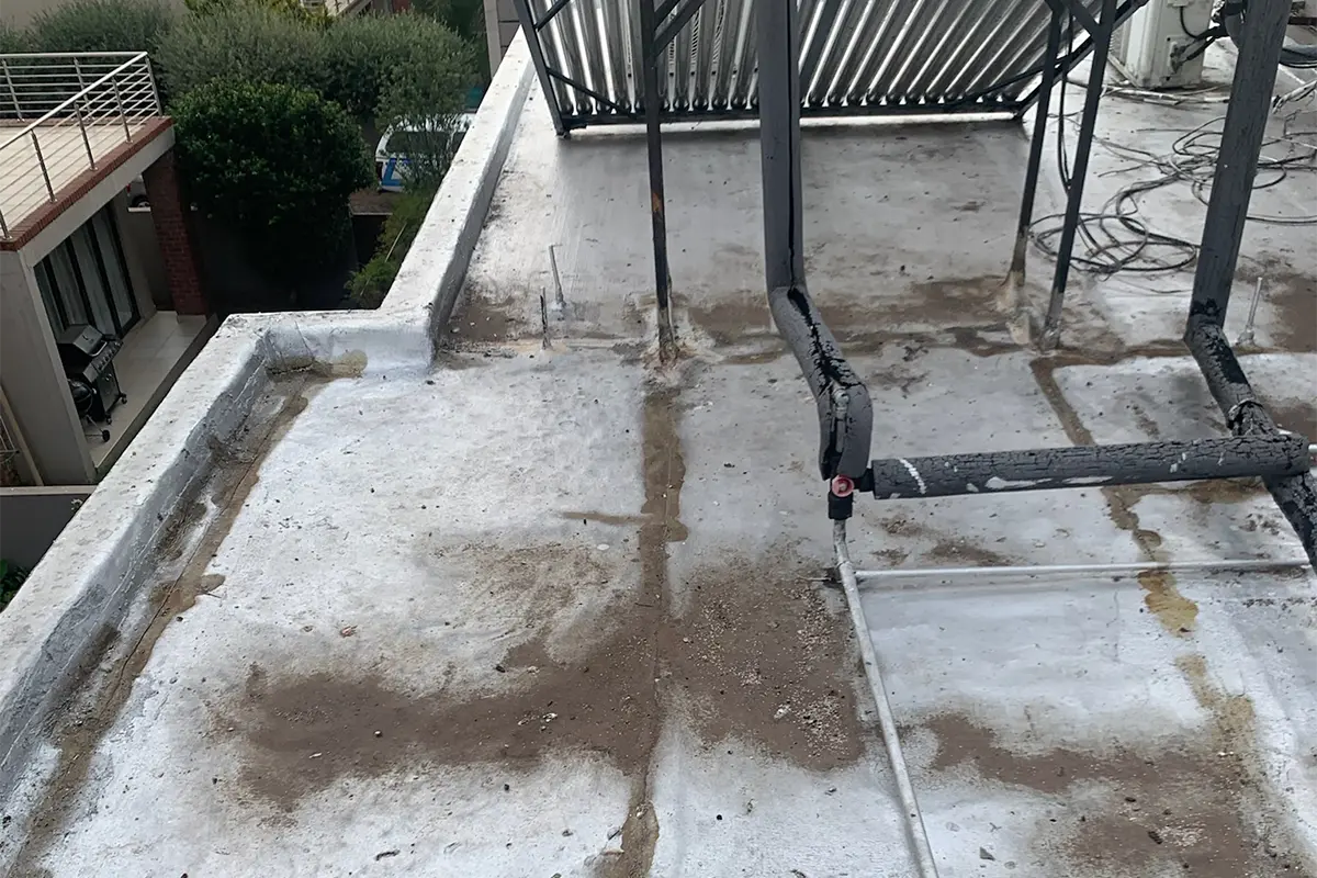 Complex roof waterproofing Randburg before work showing old failing flat roof waterproofing