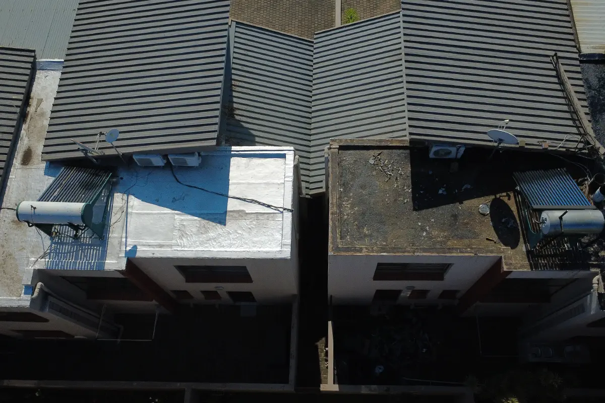 Complex roof waterproofing Randburg showing completed roof beside untreated roof section