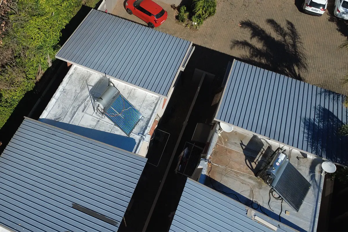 Flat roof waterproofing Randburg showing one completed section and one untreated roof section