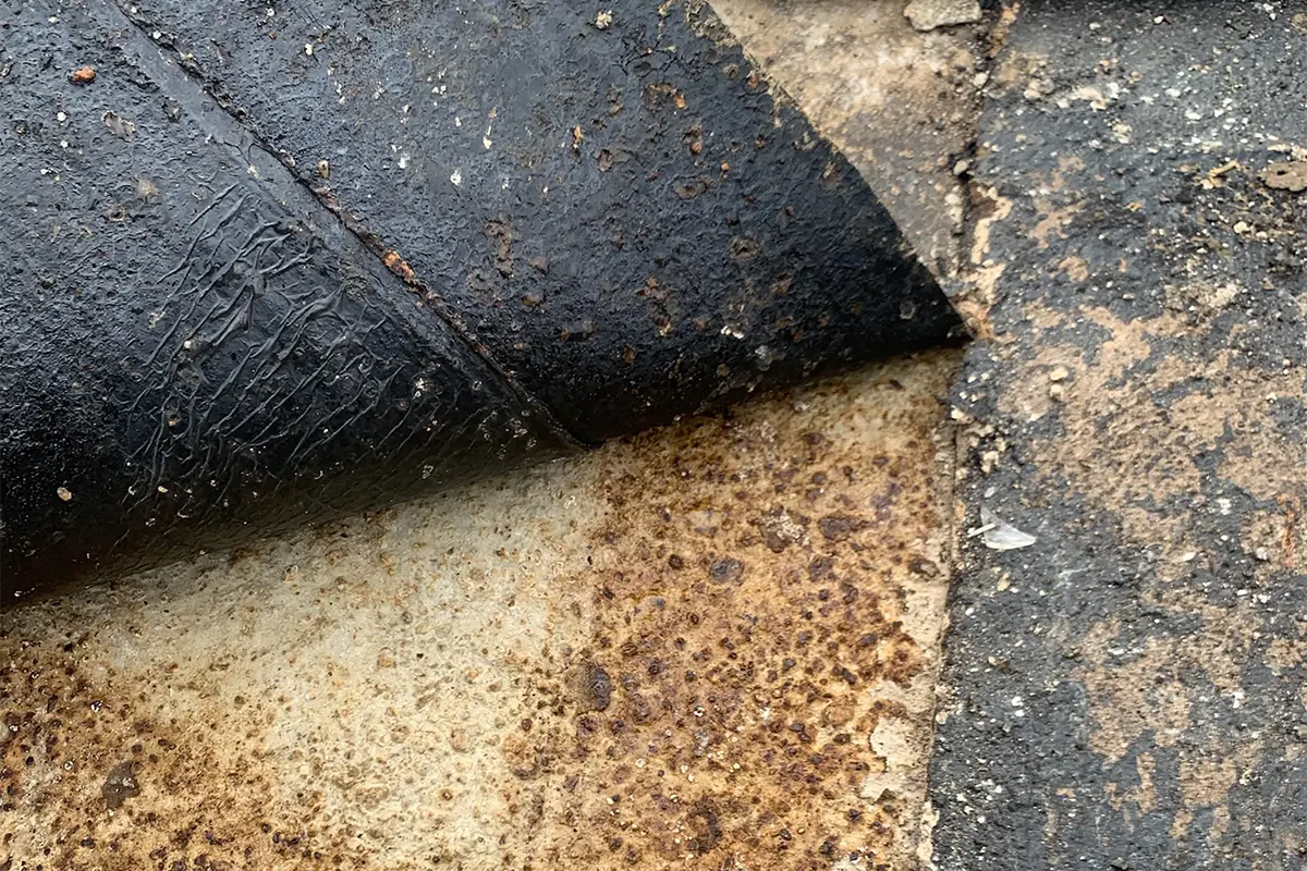 Flat roof waterproofing Randburg before work showing damp staining and water-affected roof area