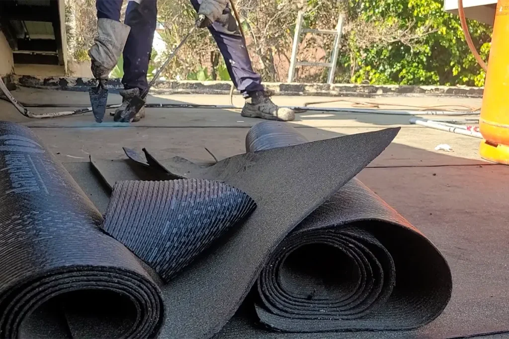 Flat roof waterproofing Randburg materials showing torch-on membrane rolls on site