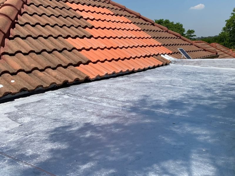 Roof area showing newly installed tiles over a torch‑on waterproofing membrane.