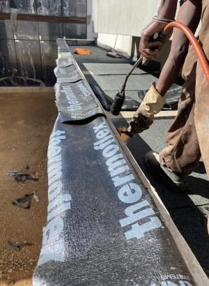 TM Waterproofing applying liquid rubber waterproofing membrane to a balcony slab in a luxury Sandton home.