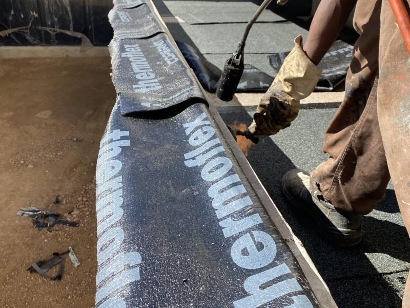 TM Waterproofing applying liquid rubber waterproofing membrane to a balcony slab in a luxury Sandton home.