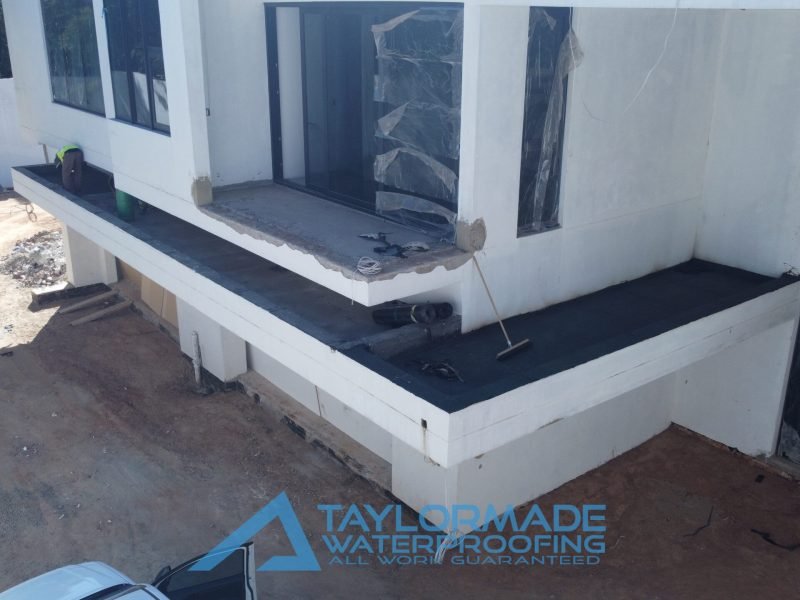 TM Waterproofing applying torch-on waterproofing membrane to balcony slab at a luxury Sandton home.