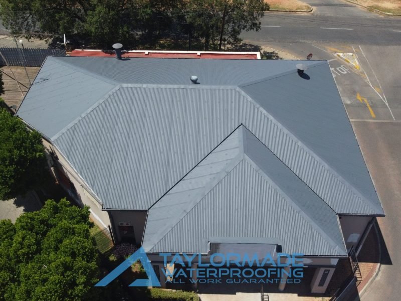 Front top view of corrugated roof showing membranes installed and protective paint applied, emphasizing roof protection and coverage.