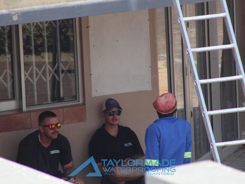 TM Waterproofing experts listening to provide updates on the corrugated roof project.