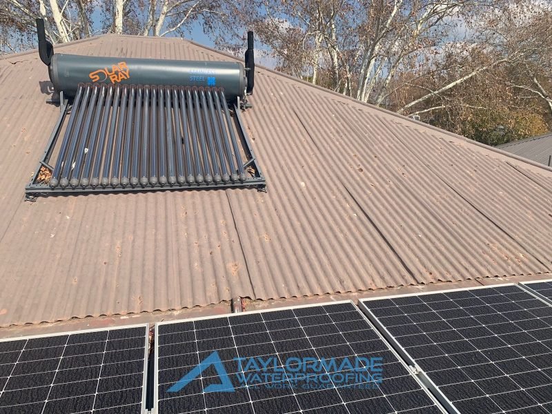 Parkhurst roof before protective coating, showing solar panels and surface condition, ready for flat roof waterproofing.