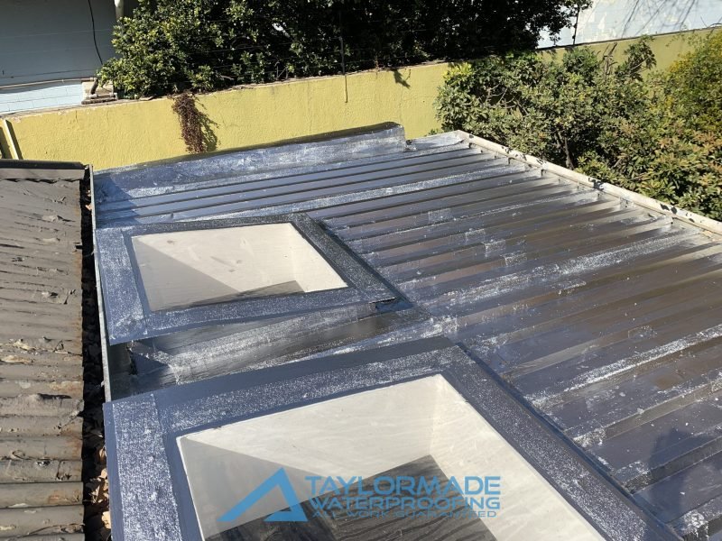 Restored Parkhurst roof with board and silver protective coating applied, showing board & torch and torch-on waterproofing protection, previously rusted and neglected.