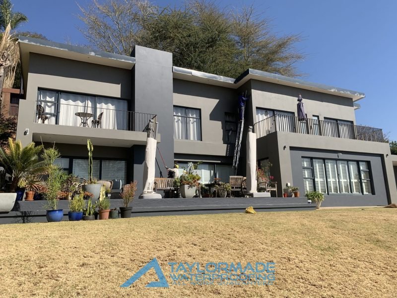 house wall after crack repair and waterproof paint application, showing a smooth and renewed surface.