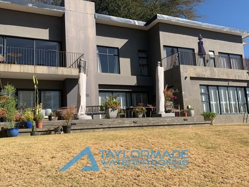 TM Waterproofing repairing and preparing an exterior wall with visible cracks, ahead of final waterproofing coating.