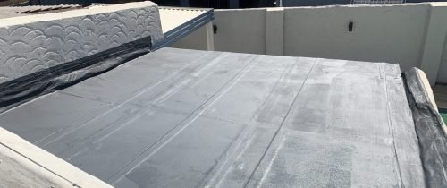 Top-right view of a flat roof with Board & Torch Waterproofing fully applied, highlighting quality installation by TM Waterproofing.
