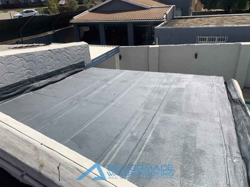 Top-right view of a flat roof with Board & Torch Waterproofing fully applied, highlighting quality installation by TM Waterproofing.