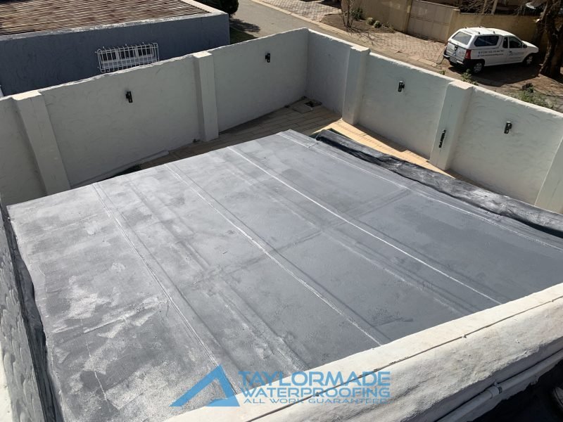 Flat roof with Board & Torch Waterproofing fully applied, highlighting TM Waterproofing’s professional roof protection work.