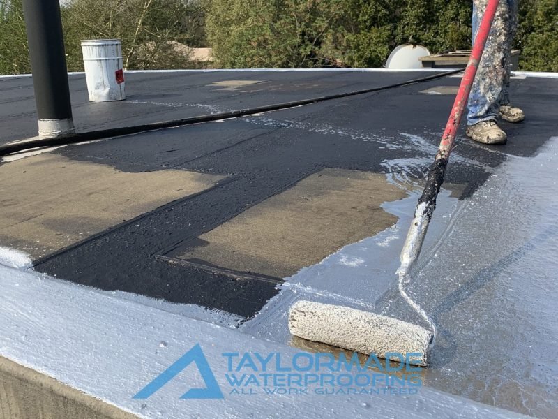 TM Waterproofing painting the roof surface during the Parktown North Roof and Balcony Waterproofing project.