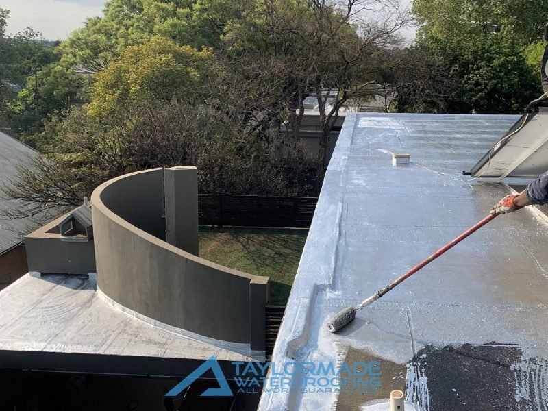 TM Waterproofing finishing the final stage of roof waterproofing at Parktown North, ensuring a smooth and sealed surface.