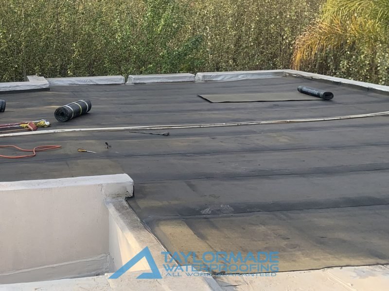 TM Waterproofing applying torch-on membranes on the roof during the Bryanston project.
