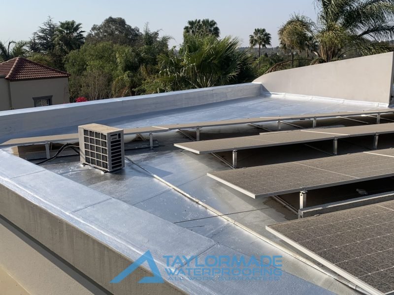 Completed protective painting on the Bryanston roof slab near solar panels for durability and weather resistance.