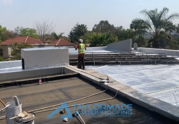 TM Waterproofing in progress applying protective paint on a Bryanston roof slab for durability and weather resistance.