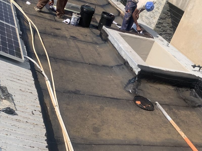 Flat slab roof in Parkhurst membranes application and painting in progress.