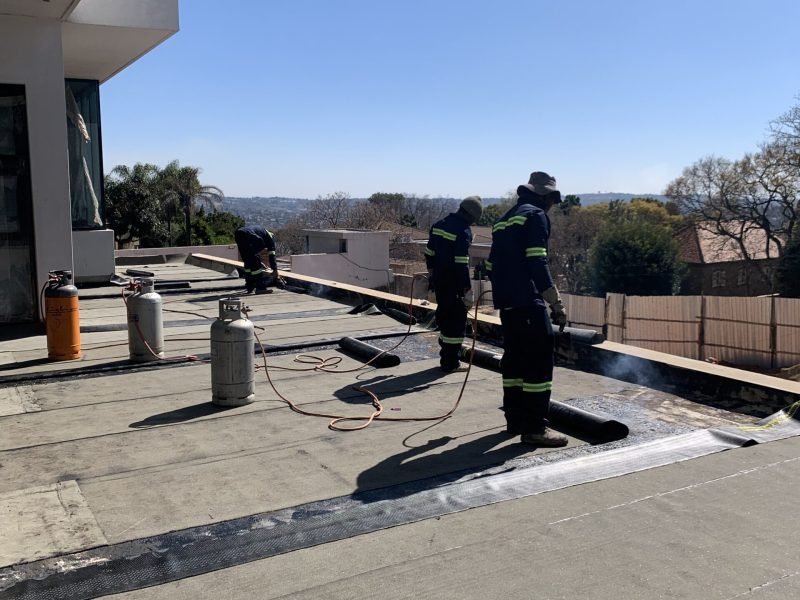 Torch on membrane applied on balcony surface during waterproofing of a luxury Sandton home.
