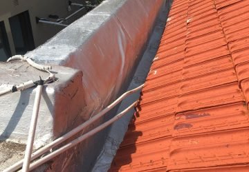 Rooftop wall fully treated with torch-on waterproofing membrane and paint finish.