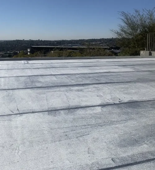 Roof waterproofing Westcliff flat roof after silver UV protective coating was applied